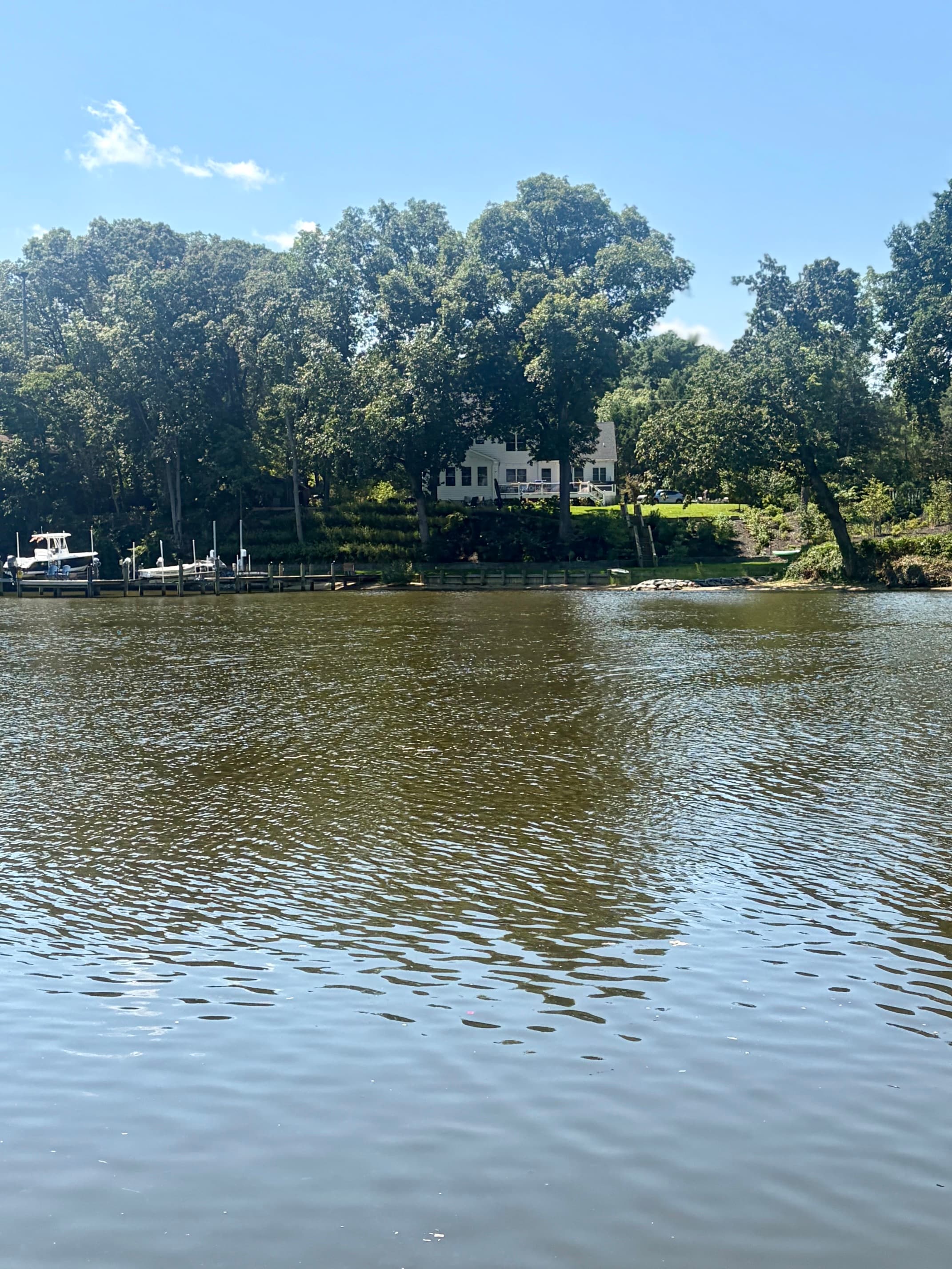 A waterfront home surrounded by trees along the water in Arnold