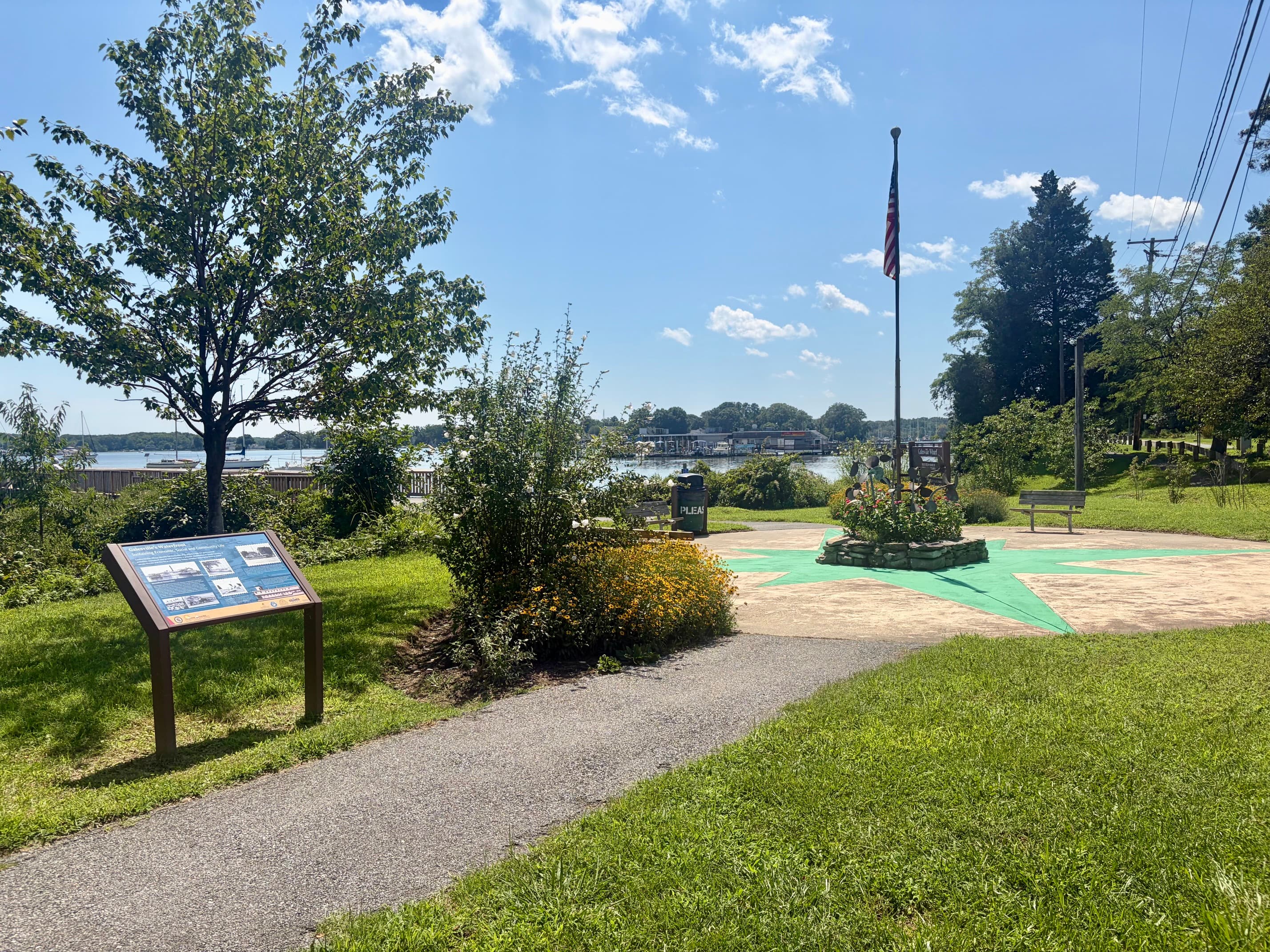 Galesville's waterfront park with a flagpole and marina in the background